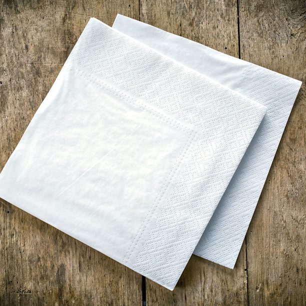 43952084 - white paper napkins on old wooden table